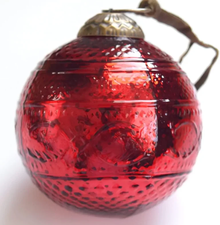 A shiny and textured antique-style cherry red Christmas tree ornament.