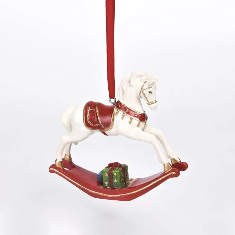A red and white Christmas ornament featuring a rocking horse attached to a red ribbon.