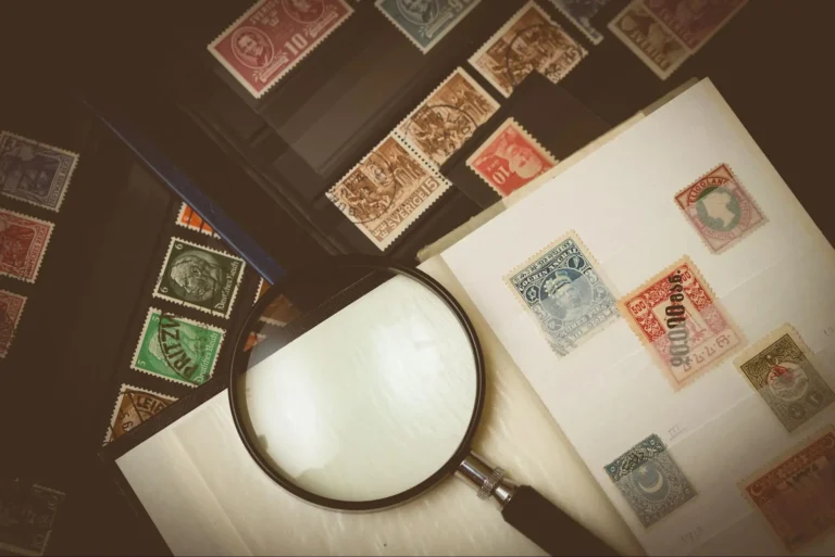 A black magnifying on top of open stamp albums.