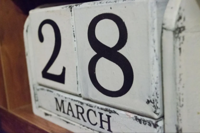 A close-up view of a wooden block calendar reading March 28th.