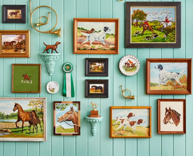 A turquoise shiplap wall filled with various drawings, illustrations, and figurines of horses and hunting dogs.