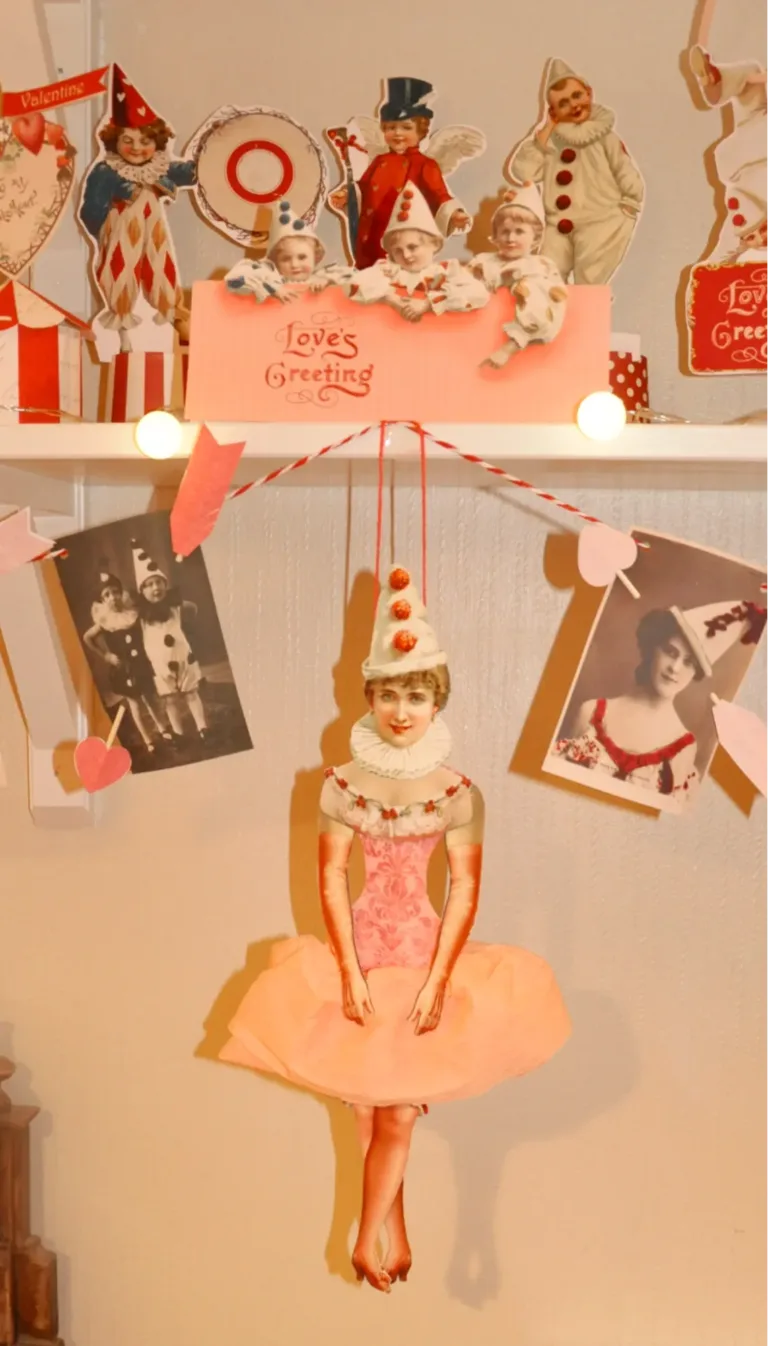 Vintage Valentine circus decorations made up of old photos and Pierrot cutouts.