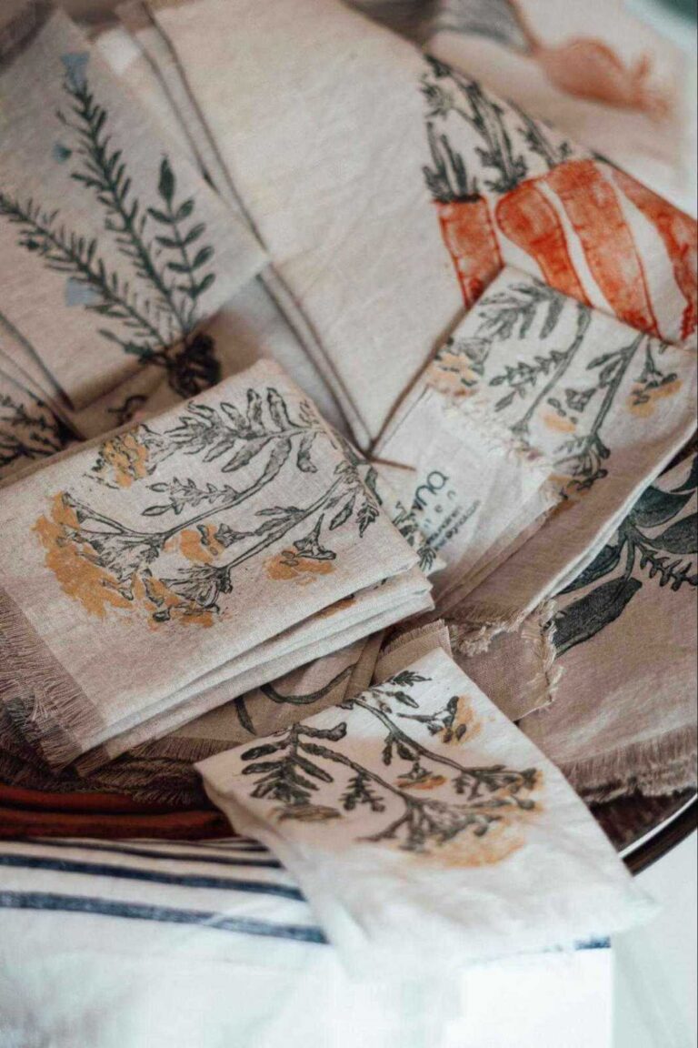 Old-style linen kitchen tablecloths with vegetable and floral designs.