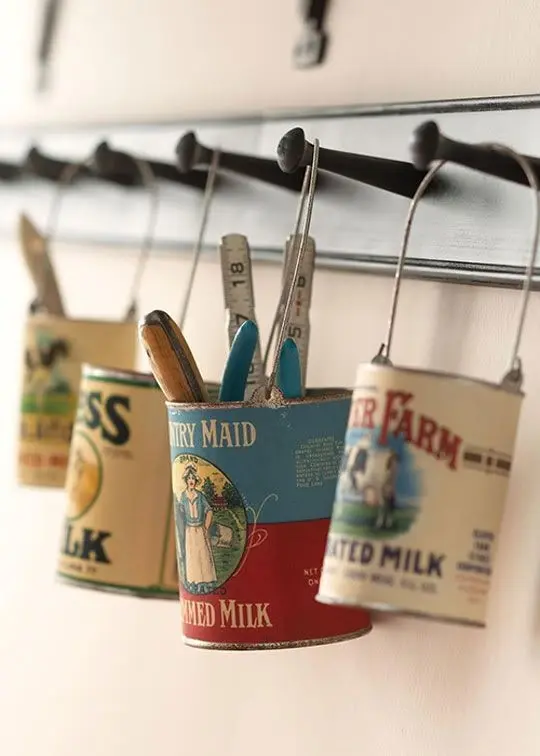 Four vintage food hanging on a wall, used as storage containers for various accessories.