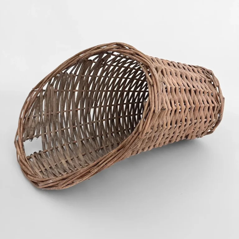 A handwoven rattan wall basket with a long back