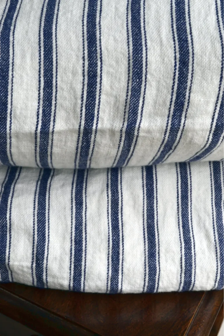 A closeup view of white and blue striped French linens.