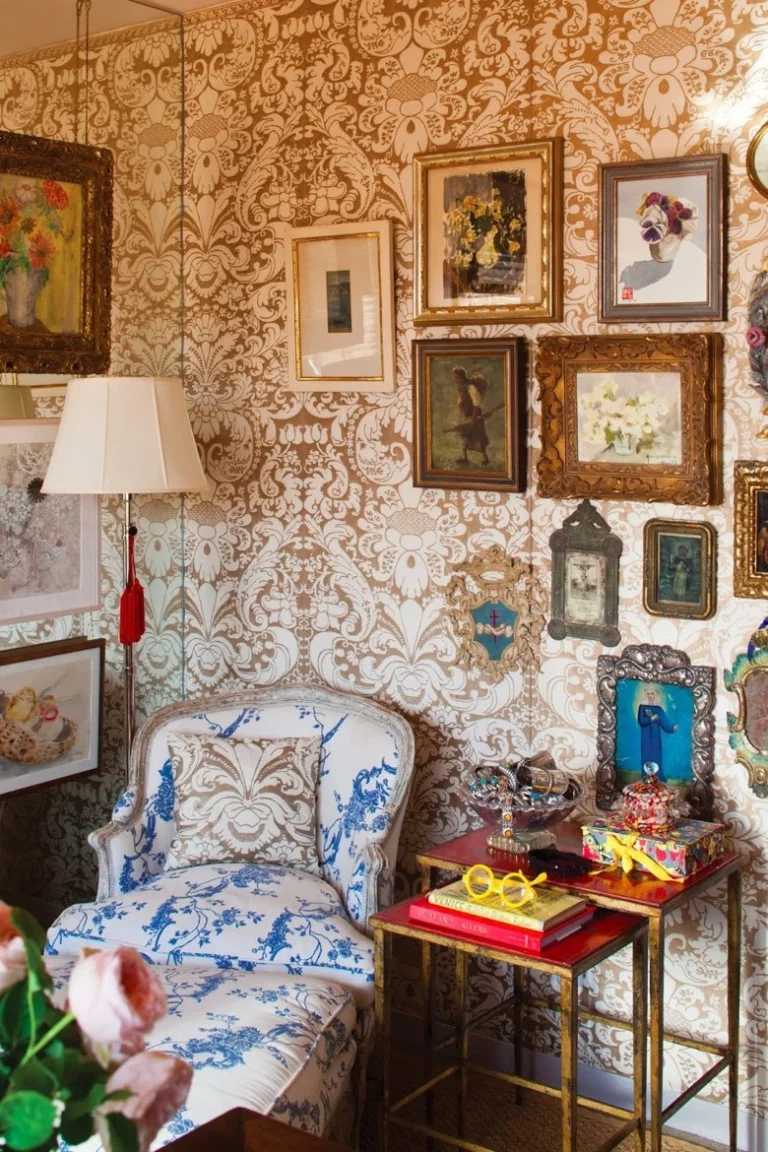 Luxurious interior with Fortuny brown fabric wall covering, antique framed art, and vintage Italian decor accents.