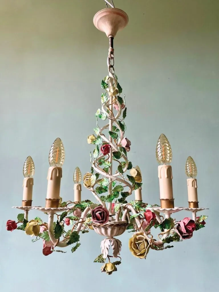 Elegant vintage Italian dining room with crystal chandelier, antique furniture, and ornate ceiling details.