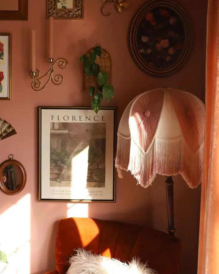Vintage home styling with a pink fringed lampshade, gold accents, and Florence wall art.