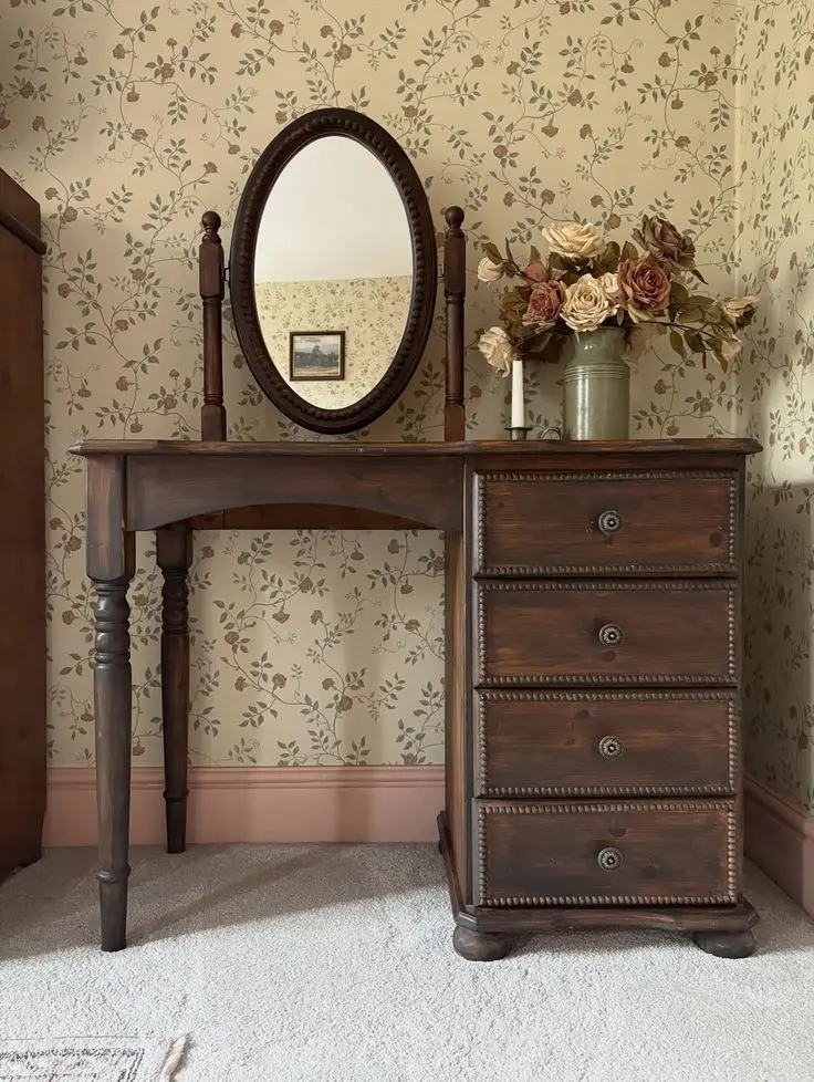 Cozy vintage bedroom with floral bedding, pastel accents, antique furnishings, and layered textiles.